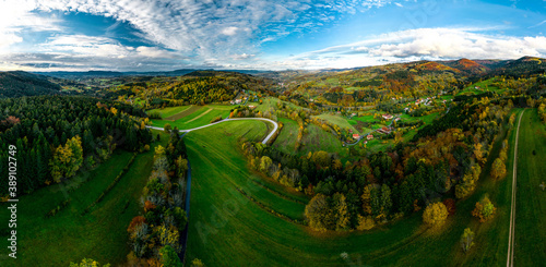 A drone rises above a multi-colored valley in the Vosges. Panoramic view.