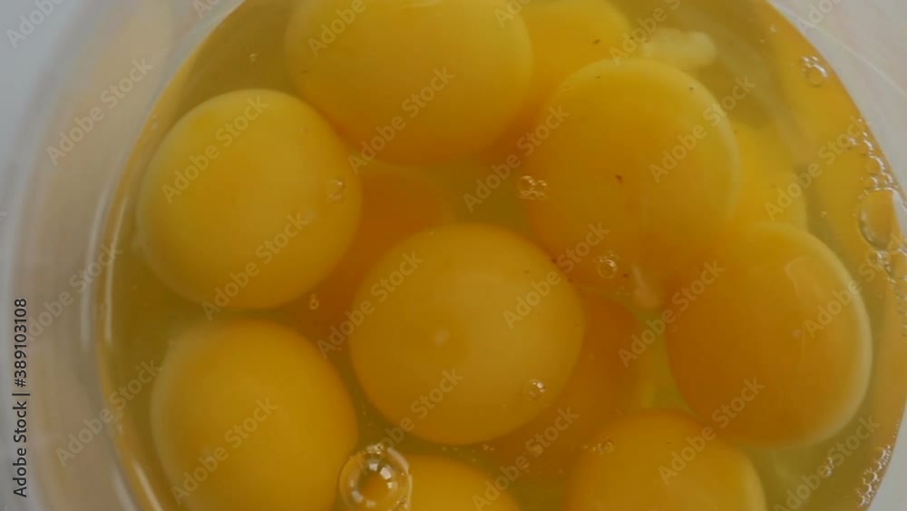 Broken eggs close-up. The hand rotates the container and removes the eggs from the frame. Real time, contains people, close-up Broken eggs close-up. The hand rotates the container and removes the eggs from the frame. Real time, contains people, close-up