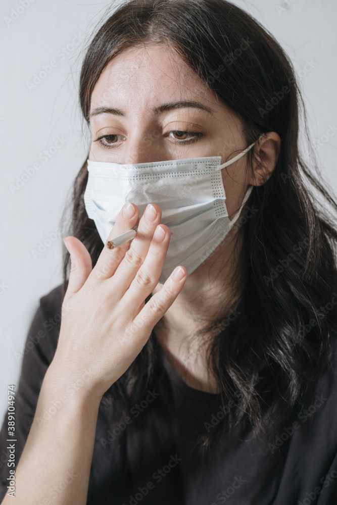 Armenian smoker tries to smoke through a mask from coronavirus, but she does not work out and she is sad Armenian smoker tries to smoke through a mask from coronavirus, but she does not work out and she is sad