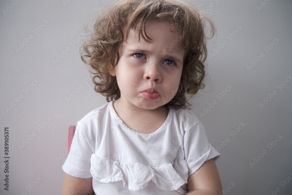 Naklejka premium Little Brazilian girl making angry face at camera
