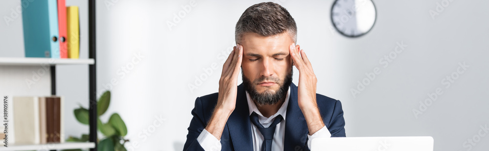 Businessman with closed eyes feeling headache while working in office, banner Businessman with closed eyes feeling headache while working in office, banner