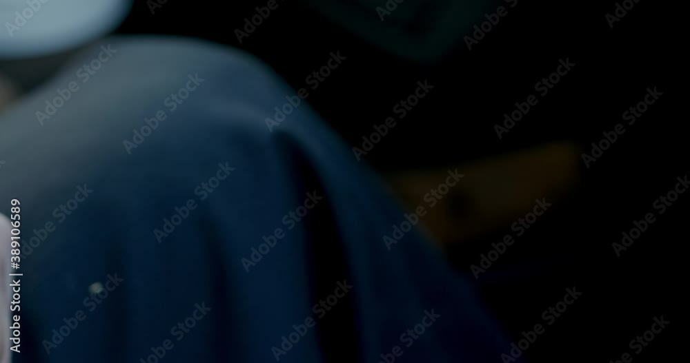Anonymous man with handgun in hand. High angle closeup of crop unrecognizable male inspecting modern black pistol gun Anonymous man with handgun in hand. High angle closeup of crop unrecognizable male inspecting modern black pistol gun
