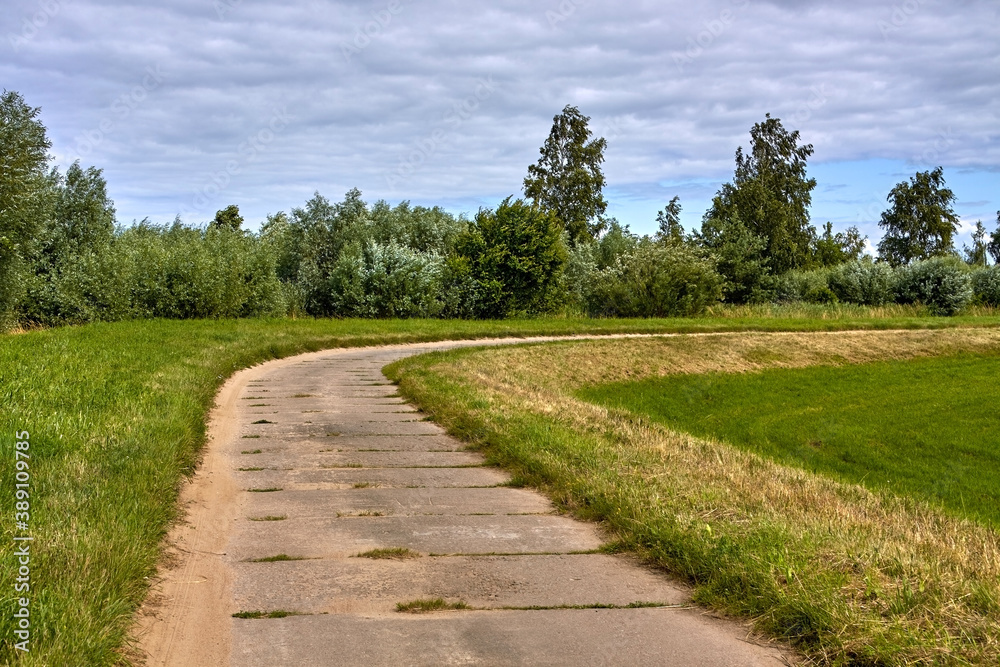 Concrete slab road along in rural area.