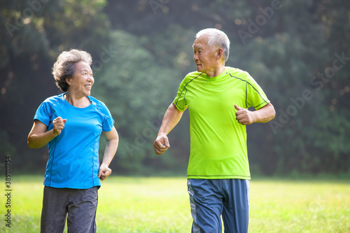 Asian Senior Couple jogging in the nature park
