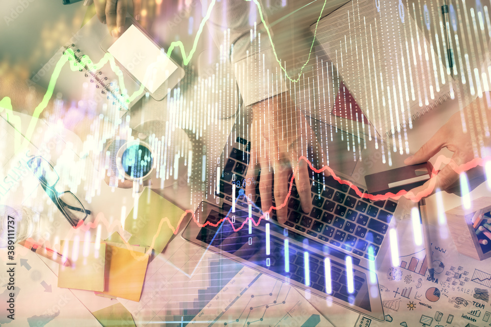 Double exposure of man and woman working together and forex graph hologram drawing. Financial analysis concept. Computer background. Top View. Double exposure of man and woman working together and forex graph hologram drawing. Financial analysis concept. Computer background. Top View.