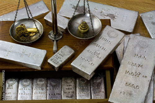 Homestake Mining Company silver bullion bars. Now closed mine located at Lead, South Dakota - Black Hills, USA. Gold bar and raw nuggets on antique balance scale.