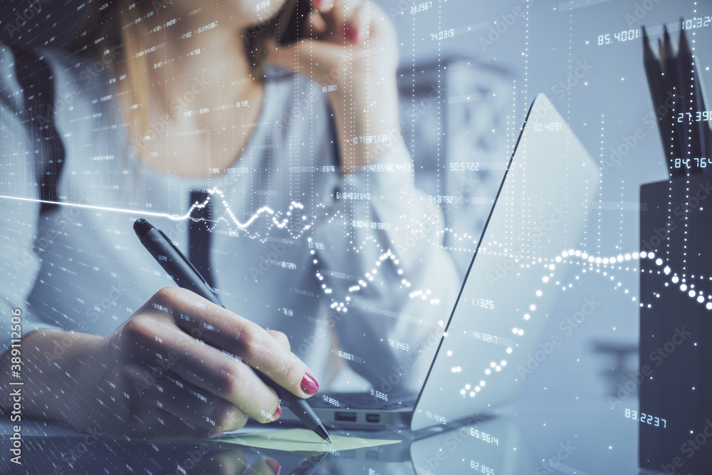 Double exposure of woman hands typing on computer and financial graph hologram drawing. Stock market analysis concept.