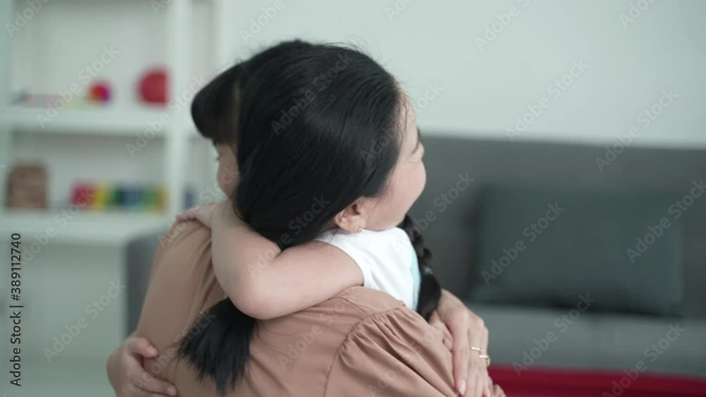 The Asian daughter was hugging her mother with happiness at home, family concept slow-motion The Asian daughter was hugging her mother with happiness at home, family concept slow-motion