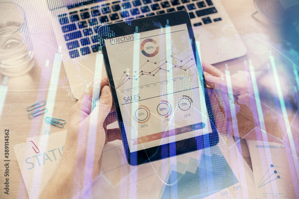 Double exposure of man's hands holding and using a digital device and forex graph drawing. Financial market concept. Double exposure of man's hands holding and using a digital device and forex graph drawing. Financial market concept.