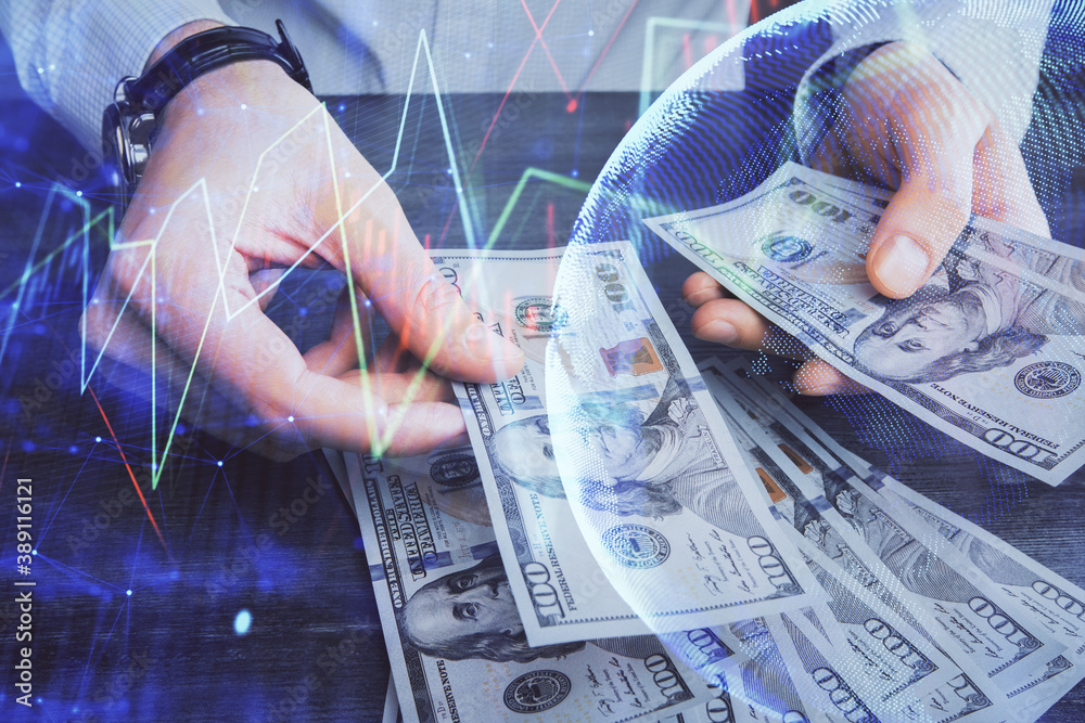 Multi exposure of financial graph drawing hologram and USA dollars bills and man hands. Analysis concept. Multi exposure of financial graph drawing hologram and USA dollars bills and man hands. Analysis concept.