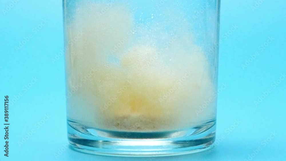 Vitamin pills in a glass with effervescent orange tablets. Vitamin pills in a glass with effervescent orange tablets.