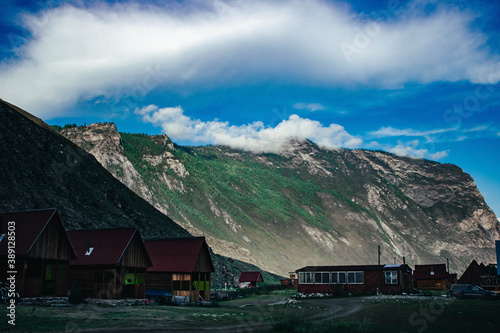 country landscape with houses and clouds