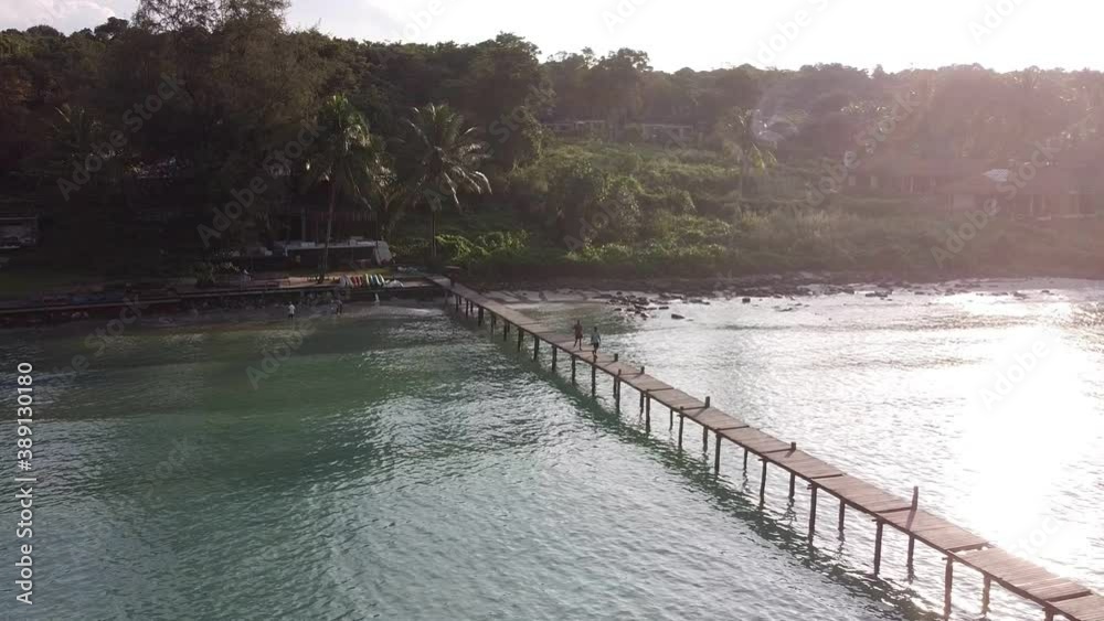 aerial view of tropical resort and wooden jetty bridge on turquoise sea. aerial view of tropical resort and wooden jetty bridge on turquoise sea.