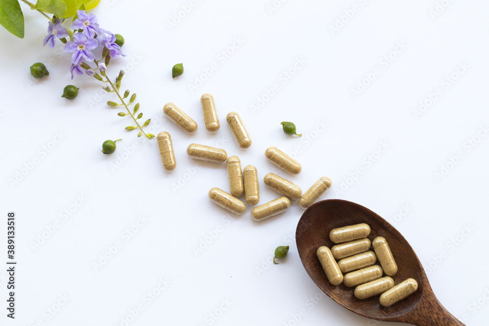 tablets capsules extract from herbal health care for woman and purple flowers arrangement flat lay style on background white tablets capsules extract from herbal health care for woman and purple flowers arrangement flat lay style on background white