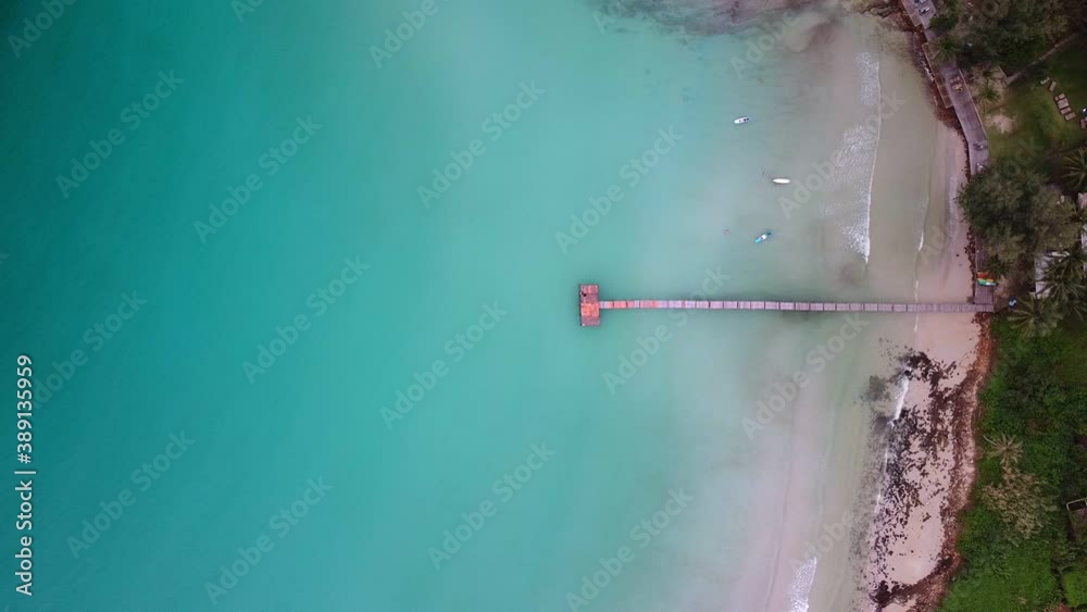 aerial view of tropical resort and wooden jetty bridge on turquoise sea. aerial view of tropical resort and wooden jetty bridge on turquoise sea.