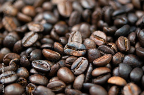 Dark roasted coffee beans close-up. Coffee background