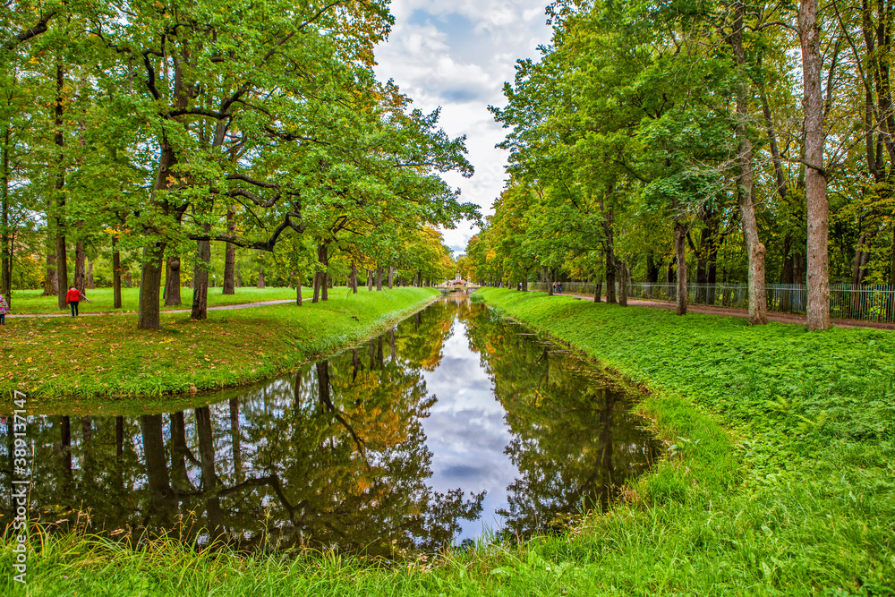 Triple alley in autumn. Bypass channel and small Chinese bridges. Alexander Park. Pushkin. St. Petersburg. Russia