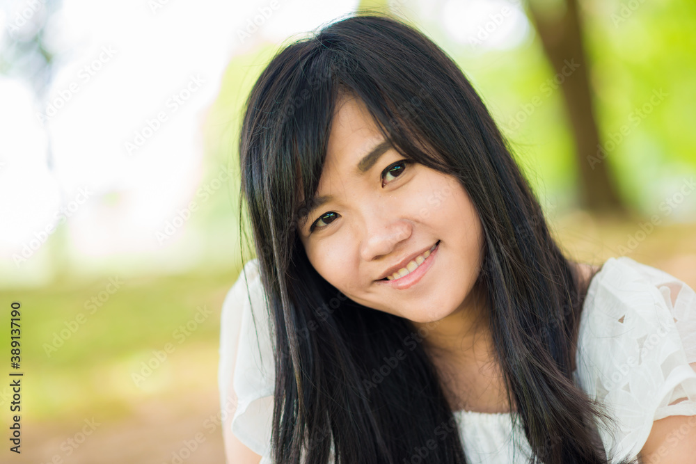 Fashion asian girl outdoor portrait walking in summer park and with long black hair Fashion asian girl outdoor portrait walking in summer park and with long black hair