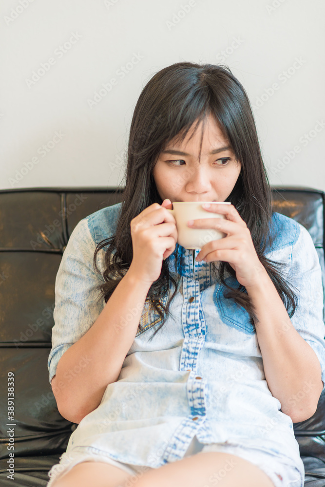 Beautiful asian women hold hot latte coffee sitting in cafe Beautiful asian women hold hot latte coffee sitting in cafe