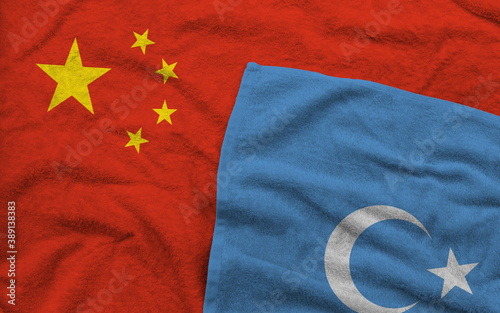 The Chinese and Uyghur flags pattern on towel fabric are placed together.