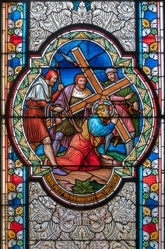 VIENNA, AUSTIRA - OCTOBER 22, 2020: The Fall of Jesus under the cross on the stained glass in church Pfarrkirche Kaisermühlen by workroom Tiroler Glasmalerei-Anstalt from end of 19. cent..