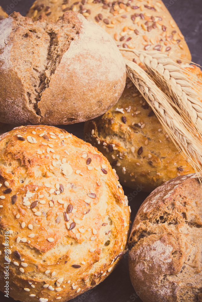 Vintage photo, Wholegrain rolls or bread for breakfast and ears of rye or wheat grain