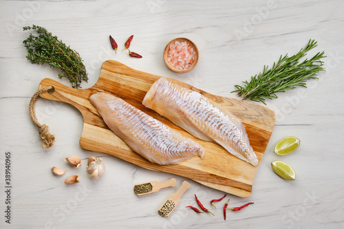 Photos Top view of haddock fillet with seasoning