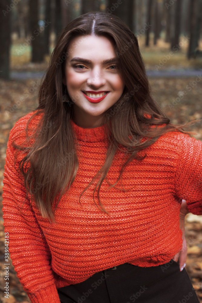 Brunette in autumn Park and autumn leaves. Autumn mood. Yellow, red and green leaves. Brunette in autumn Park and autumn leaves. Autumn mood. Yellow, red and green leaves.