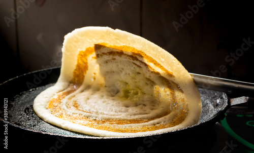 Fresh dosa cooked on a tawa