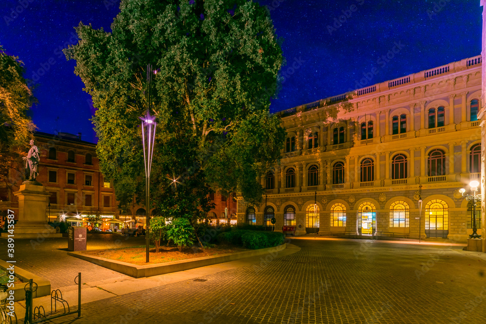 Minghetti square with statue, shops and centuries-old tree, Bologna, Italy