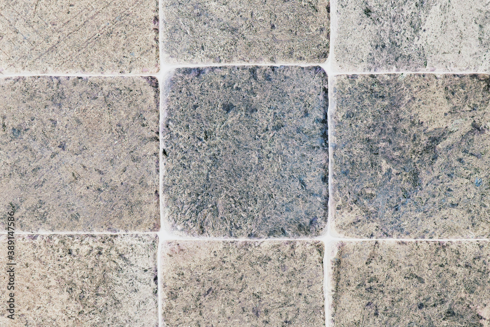 Fototapeta premium Light pale stone background with inverted colors. Beige with blue backdrop or wallpaper. Rough matte surface. Pattern of scratches, blotches and processing marks