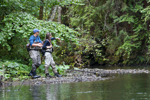 Young woman learning to fly fishing with a profesional guide