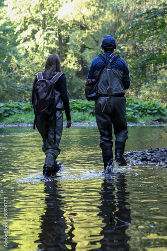 Young woman learning to fly fishing with a profesional guide