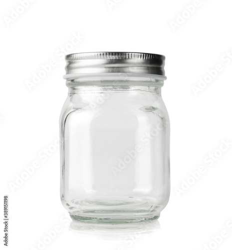 Empty glass jar with silver lid isolated on white.
