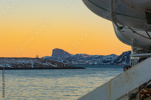 Passing the Northern Polar Circle Globe on the norwegian island Vikingen with cruise ship in early morning photo