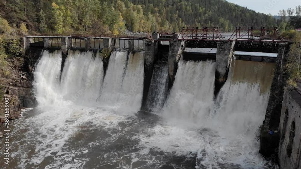 Water spills over the top of Dam on the River Water spills over the top of Dam on the River