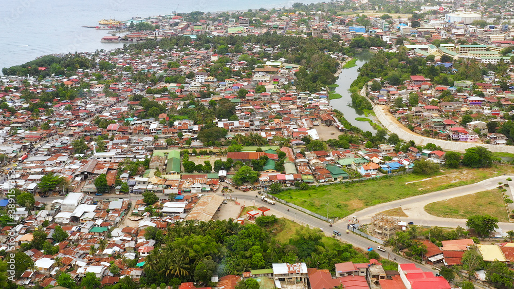 Aerial drone of city of Iligan near the sea on the island of Mindanao, Philippines. Iligan City, Lanao del Norte.