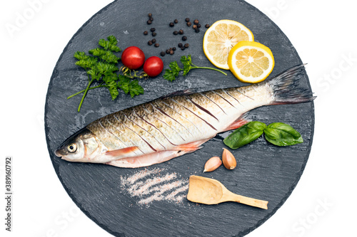 Fish with aromatic herbs, spices and vegetables - healthy food, diet or cooking concept