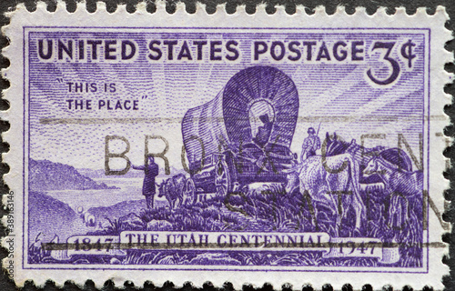 USA - Circa 1947: a postage stamp printed in the US showing the first settlers entering the Great Salt Lake valley and the words "This is the Place," Text: Utah Centennial