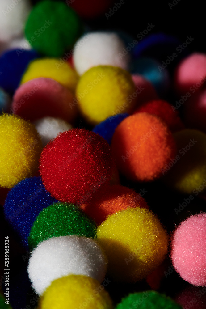Fluffy and colorful litle balls on black background Fluffy and colorful litle balls on black background