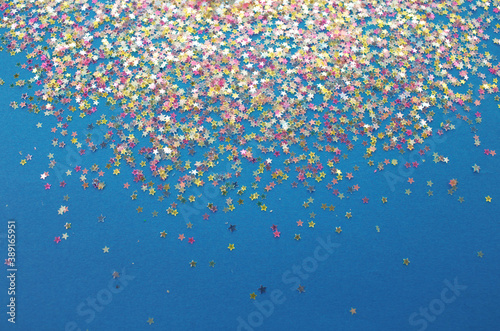 Fototapeta Naklejka Na Ścianę i Meble -  multicolored confetti on a blue background top view
