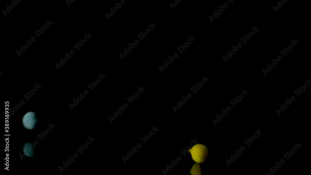 Fluffy and colorful little balls on black background