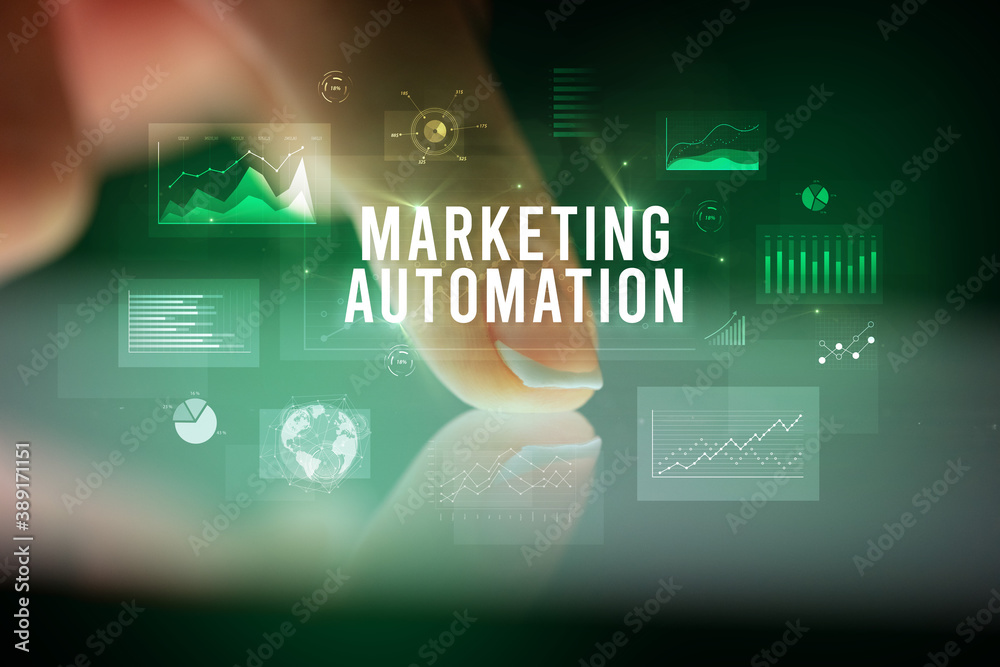 Finger touching tablet with charts and MARKETING AUTOMATION inscription, business concept