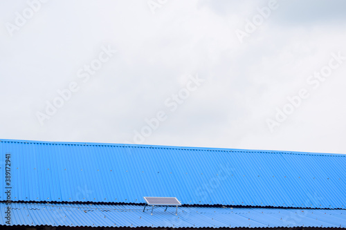 Roof of a building made of tin and solar panel on it