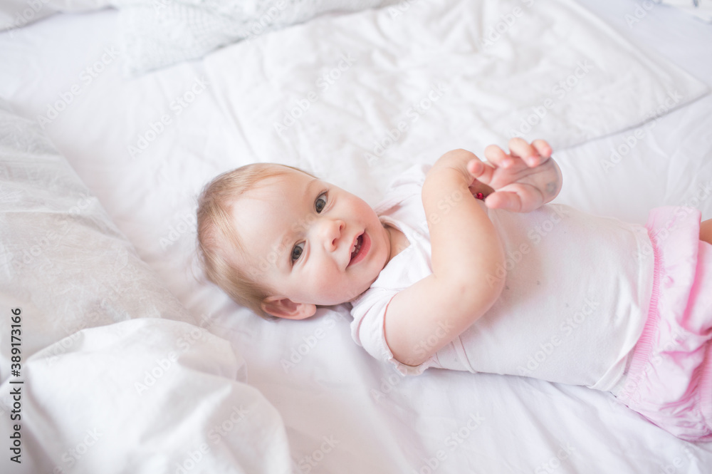 little cute girl playing in bed laughing and smiling little cute girl playing in bed laughing and smiling