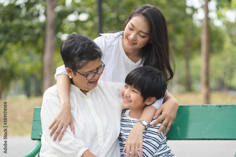 Group of people in family in multi generation hugging together Group of people in family in multi generation hugging together