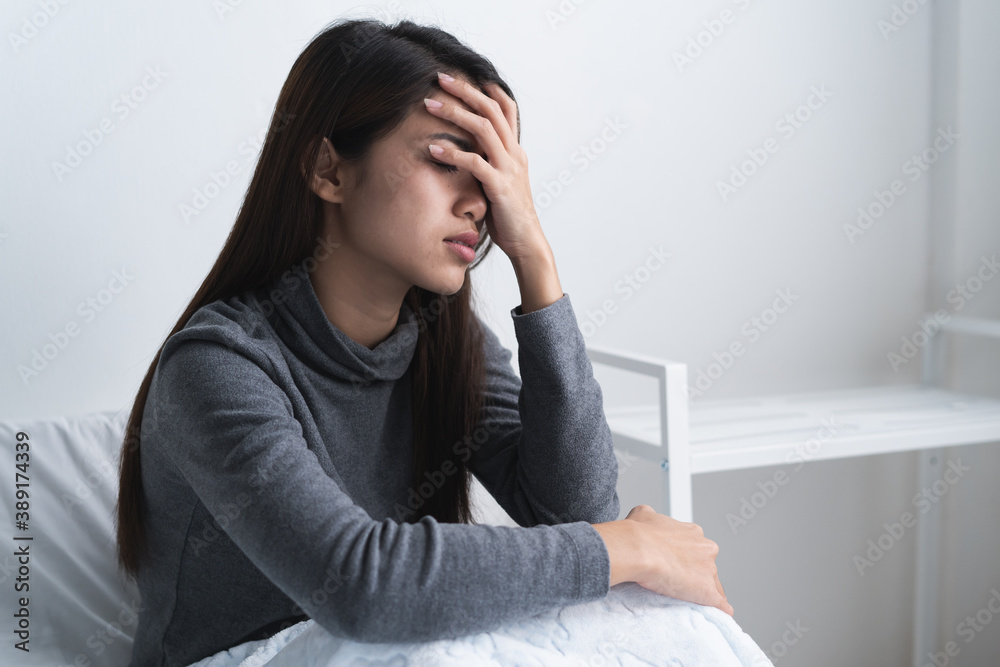 Suffer from depression , mental health problem. Lonely asian young woman sitting on the bed feeling loneliness. Suffer from depression , mental health problem. Lonely asian young woman sitting on the bed feeling loneliness.