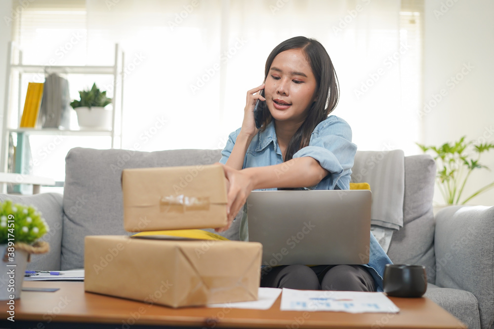 woman working at home have a online shop on web and prepare parcel for client woman working at home have a online shop on web and prepare parcel for client