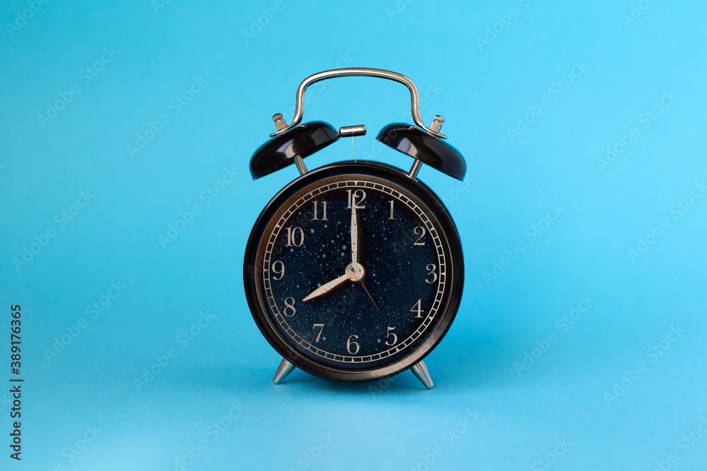 Wake up concept: alarm clock ringing at 8am on blue background Wake up concept: alarm clock ringing at 8am on blue background