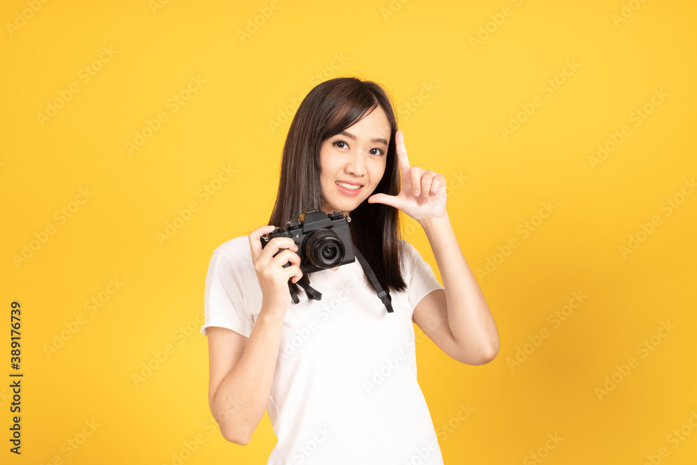 Happy smiling asian young girl photographer takes images with dslr camera Happy smiling asian young girl photographer takes images with dslr camera